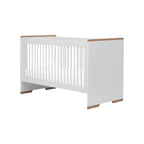 White crib with wooden accents on a white background