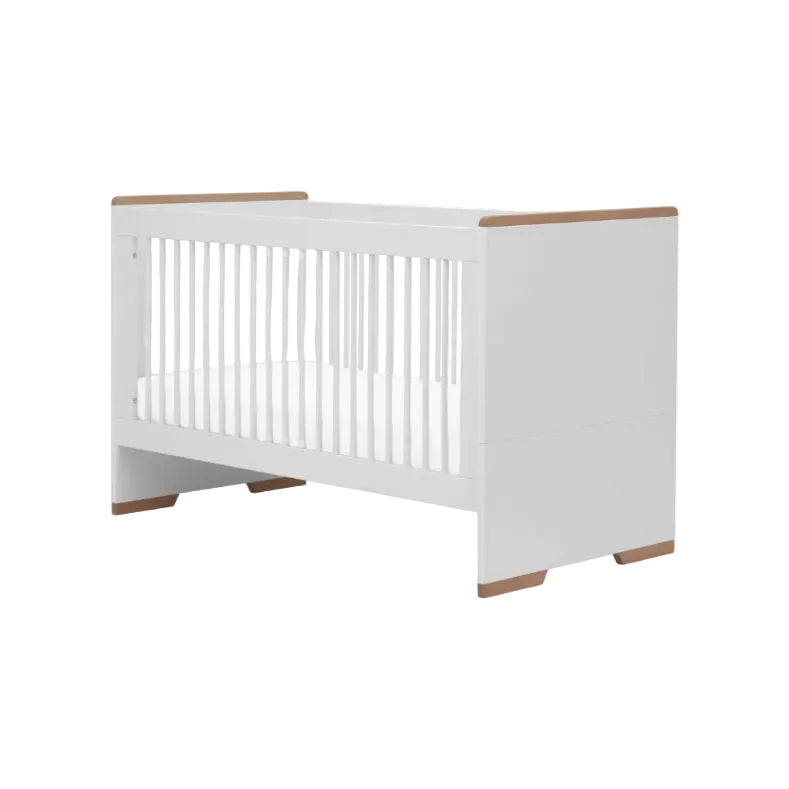 White crib with wooden accents on a white background